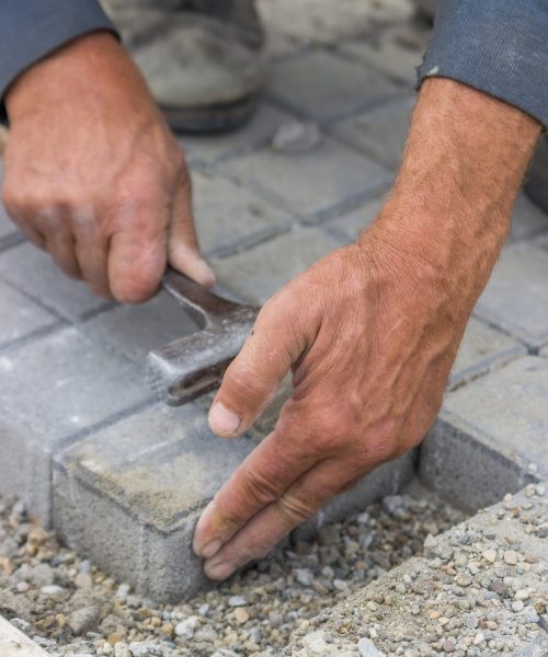 hands-of-a-manual-worker-laying-concrete-brick-pav-2026-03-26-07-30-57-utc
